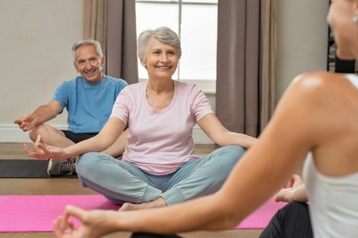 Senior Couple Sitting with Yoga Instructor