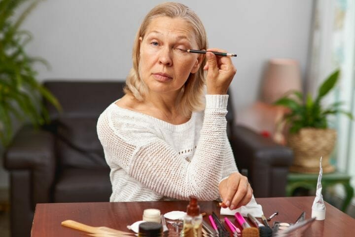 Woman Applying Eyeliner