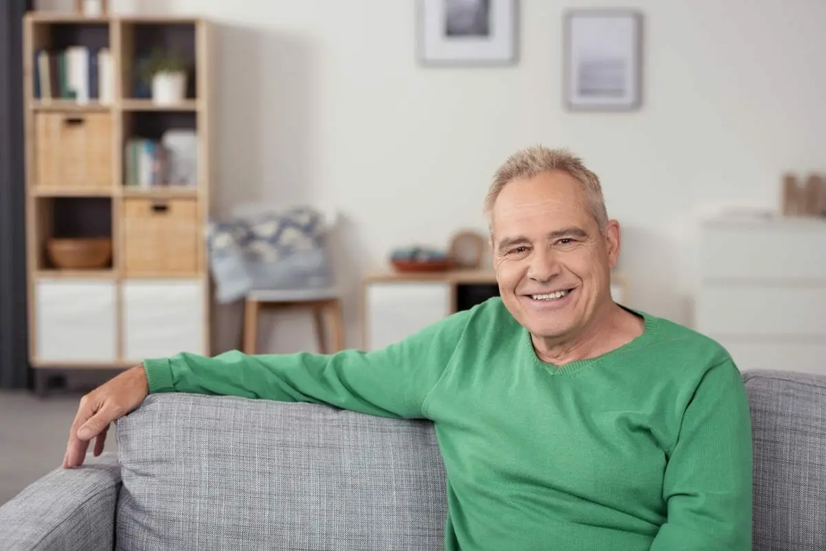 Senior Man Sitting on Couch in His House