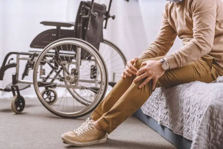 Paraplegic sitting on a bed