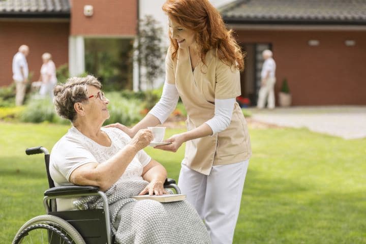 senior woman with nurse staff