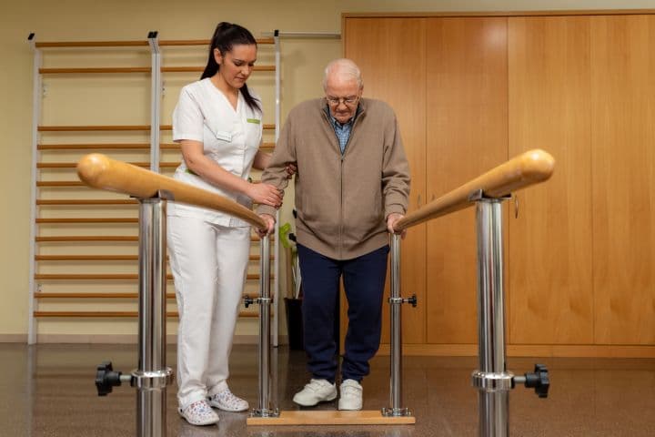 nurse assisting senior stroke patient 