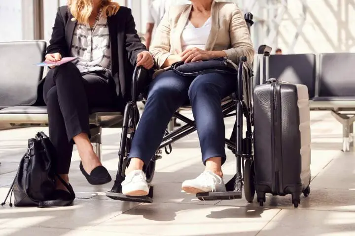 Woman on a wheelchair talking to a business woman sitting beside her