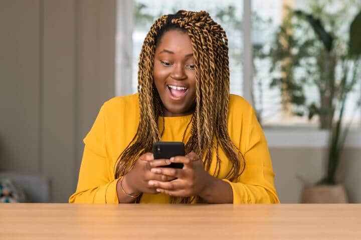 Surprised Plus sized woman using her phone