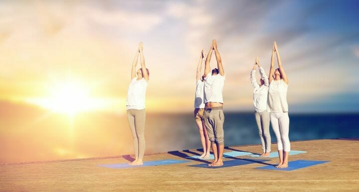 Group of people doing Urdhva Hastasana pose