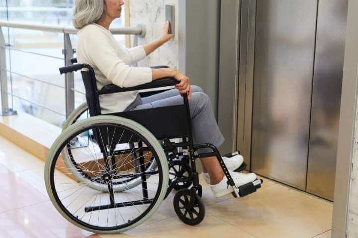 woman on wheels using elevator