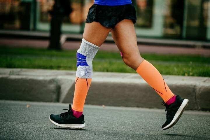 woman using compression sock while running
