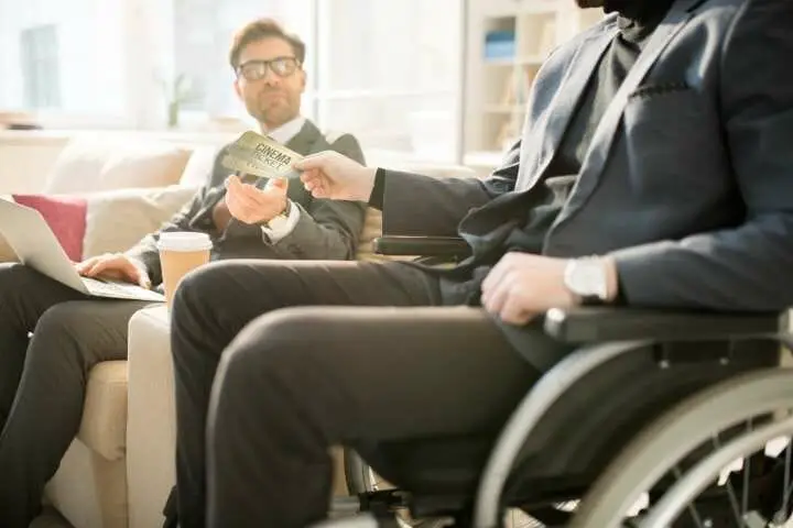 man on wheelchair with ticket