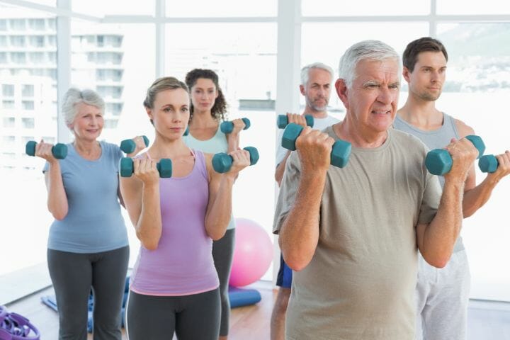 Class exercising with dumbbells