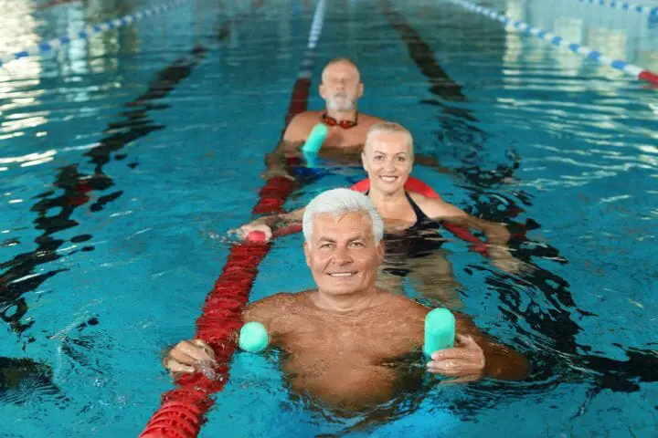 Three Seniors doing Water Aerobic Exercises