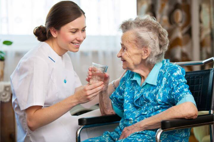 caregiver-and-elderly woman in wheelchair