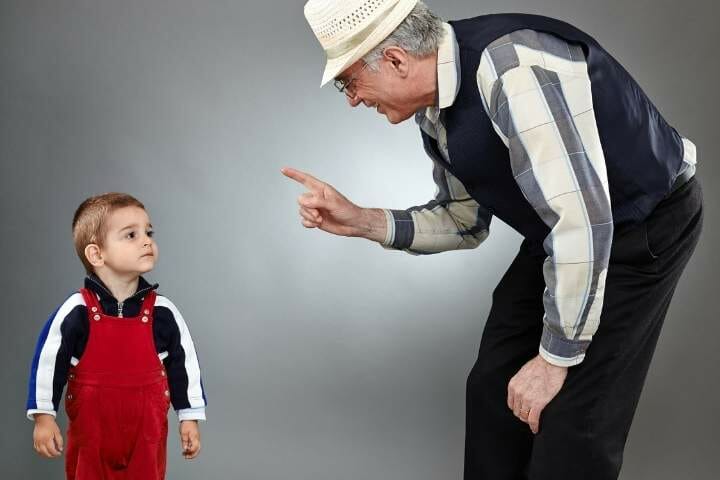 grandfather disciplining his grandson