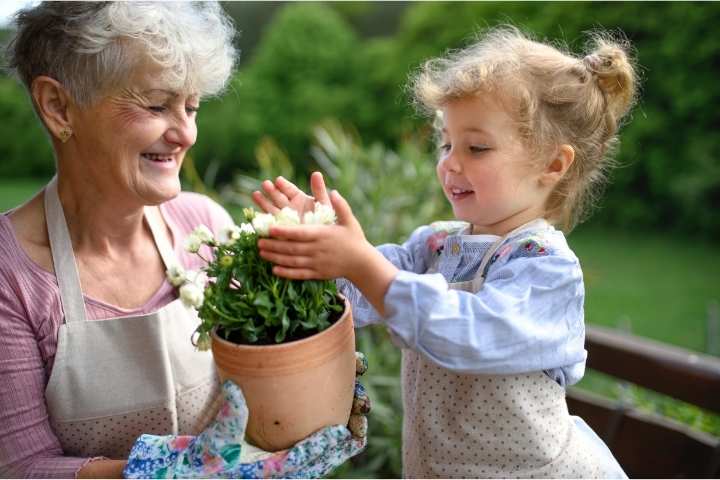 grandma and granddaughter taking care of plants