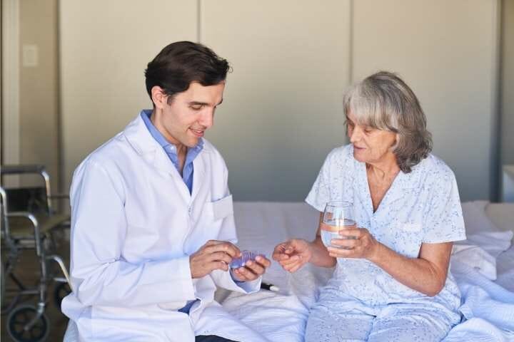 elderly woman taking medicine