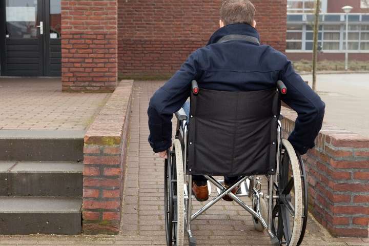 man on a wheelchair using ramp