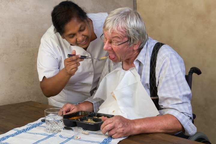 Nurse helps patient to eat