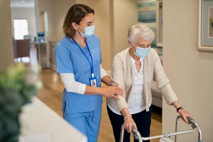 Nurse helps patient to walk