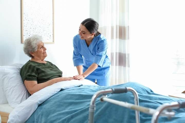 nurse taking care of elderly woman