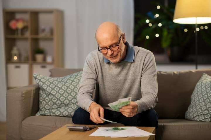 senior man counting money