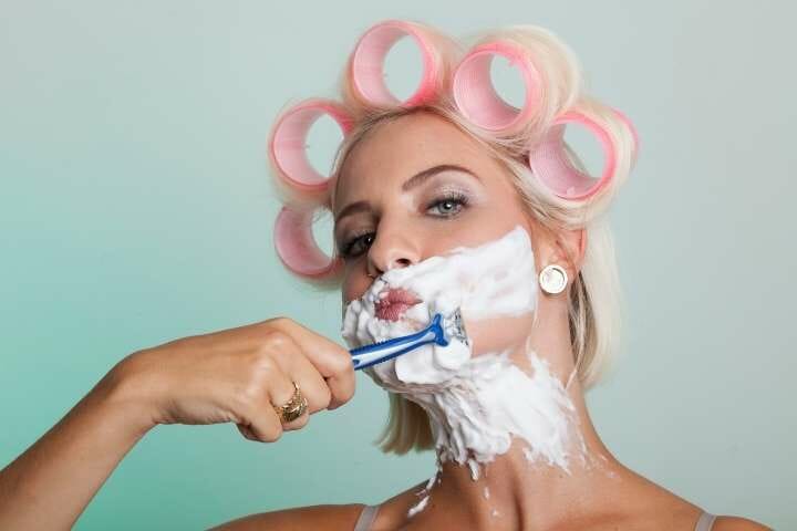 woman shaves her beard
